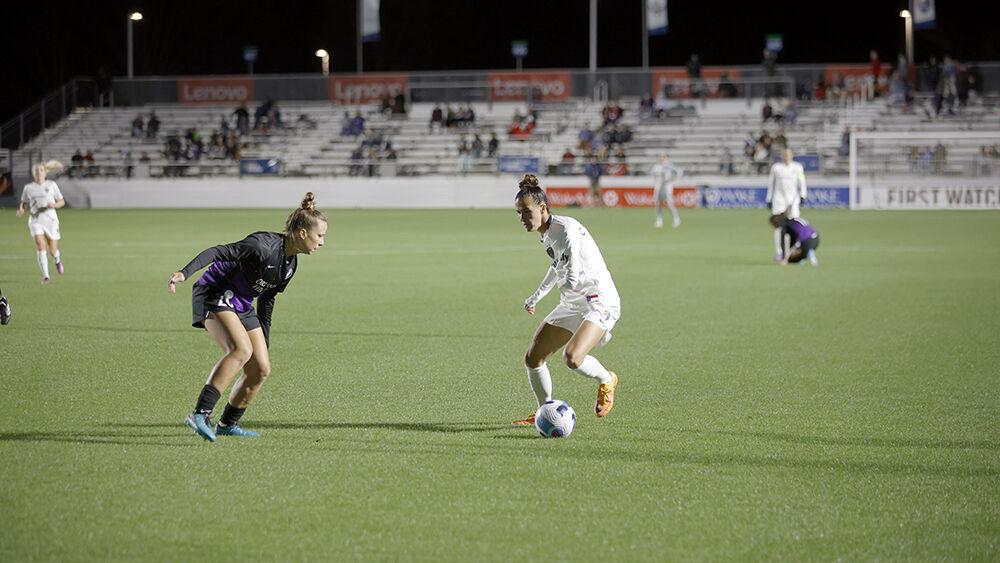 NC Courage defender Carson Pickett squares up with an Orlando Pride defender during the preseason match in Sahlen&#8217;s Stadium at WakeMed Soccer Park on Saturday, March 26, 2022. NC Courage beat Orlando Pride 1-0.