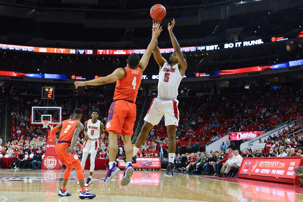 Redshirt senior guard Thomas Allen shoots the ball over the block in the game against Clemson on Saturday, Jan. 8, 2022 at PNC Arena. Allen scored 10 points and contributed 3 rebounds. NC State lost to Clemson 70-65.