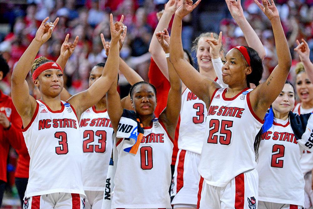 The NC State women&#8217;s basketball team holds up wolfies after the second round game of the NCAA tournament against Kansas State at Reynolds Coliseum on Monday, March 21, 2022. The Wolfpack beat the Wildcats 89-57 and advance to the sweet 16.