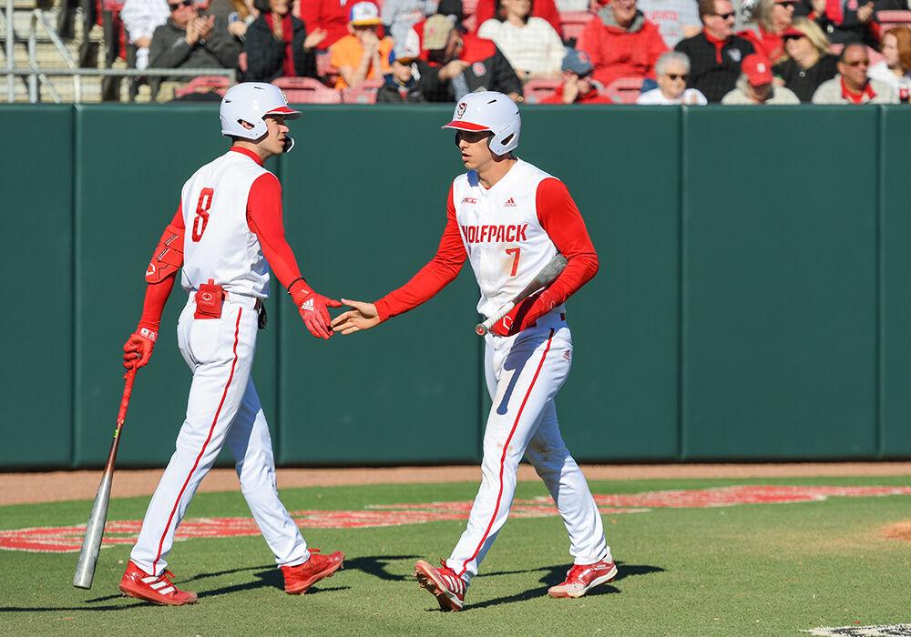 Redshirt junior infielder Josh Hood high fives freshman infielder Payton Green in the game versus Evansville on Saturday, Feb. 19, 2022 at Doak Field. NC State won the game against Evansville with a score of 6-4.