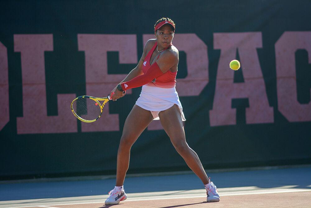 Gradate student Jaeda Daniel backhands the ball during the match against Florida State University at Dail Outdoor Tennis Center on Friday, Mar. 4, 2022. The Wolfpack beat the Seminoles 6-1.