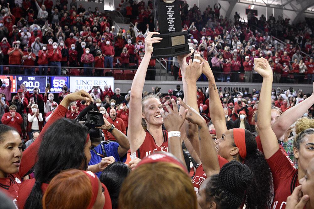 Senior center Elissa Cunane celebrates the regular season title with her teammates after the senior day game against Syracuse on Sunday, Feb. 20, 2022 at Reynolds Coliseum. NC State beat Syracuse 95-53.