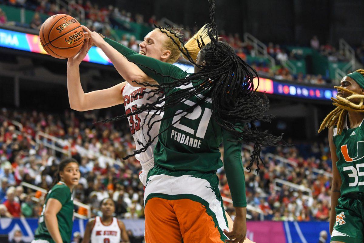 Senior center Elissa Cunane reaches for the net during the ACC championship game against the University of Miami on Sunday, March 6, 2022 inside Greensboro Coliseum. Cunane led the team in amount of points scored, making 17 overall. NC State won the game 60-47.