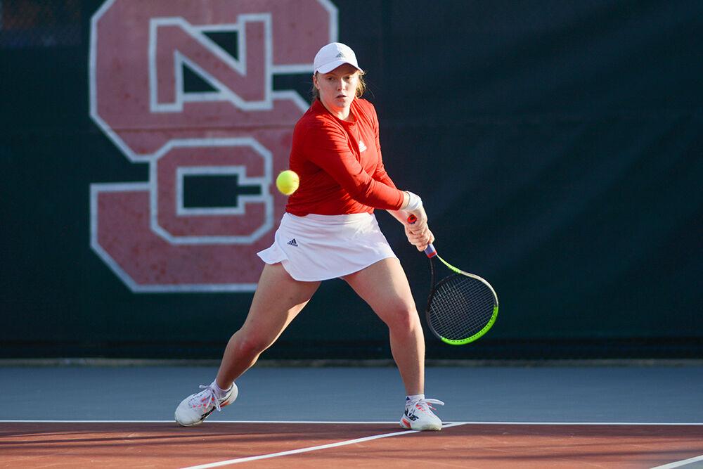 Sophomore Sophie Abrams backhands the ball during the match against Florida State University at Dail Outoor Tennis Center on Friday, March 4, 2022. Abrams won her singles match and the Wolfpack beat the Seminoles 6-1.