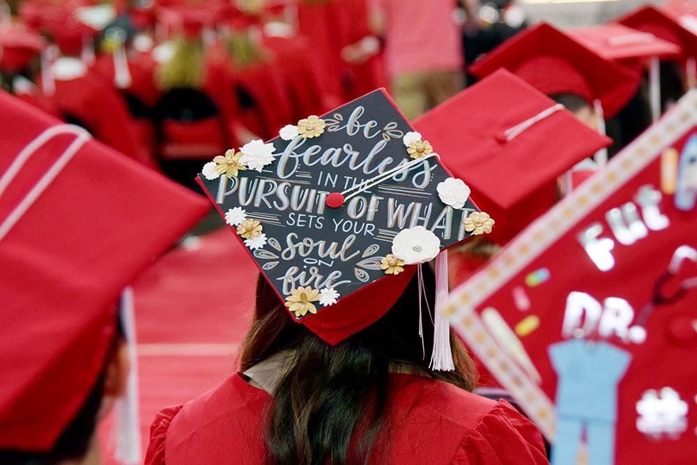 A graduate sits with her decorated cap on during the Commencement Ceremony on Saturday, May 11, 2019 in PNC Arena. It is a tradition to decorate your cap for graduation day.
