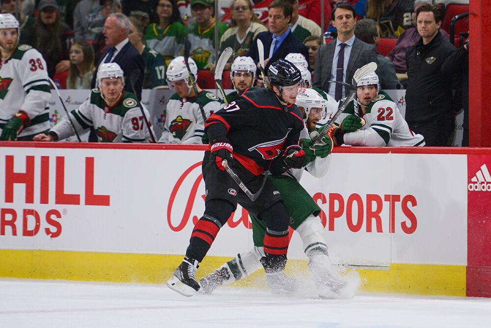 Carolina Hurricanes right wing Andrei Svechnikov body checks a player from the Minnesota Wild into the bench during the game on Saturday, April 2, 2022 in PNC Arena. Svechnikov had 4 of the teams 13 total hits during the night.&#160;The Hurricanes lost to the Wild 3-1.