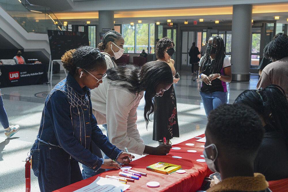 Students make buttons during the Say It Loud kick-off event for Pan-Afrikan Week on Monday, March 4, 2022 at Talley Student Union. The Say It Loud Kick-off event was the first event of Pan-Afrikan Week 2022.