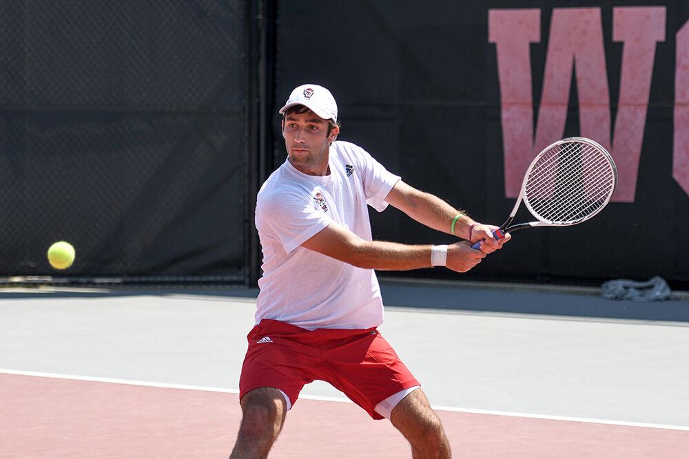 Senior Rafa Izquierdo Luque watches the ball and prepares to swing in his singles match against UNC-Chapel Hill player Brian Cernoch on Sunday, April 17, 2022 at the J.W. Isenhour Tennis Center. Izquierdo Luque lost the singles match with a score of 2-1. The Wolfpack lost to the Tarheels 4-3.