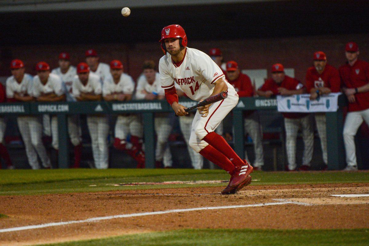 Freshman catcher Jacob Cozart bunts during NC State's home game against East Carolina on Tuesday, April 26, 2022 in Doak Field at Dail Park. Cozart scored two runs during the Wolfpack's 12-3 win over the Pirates.