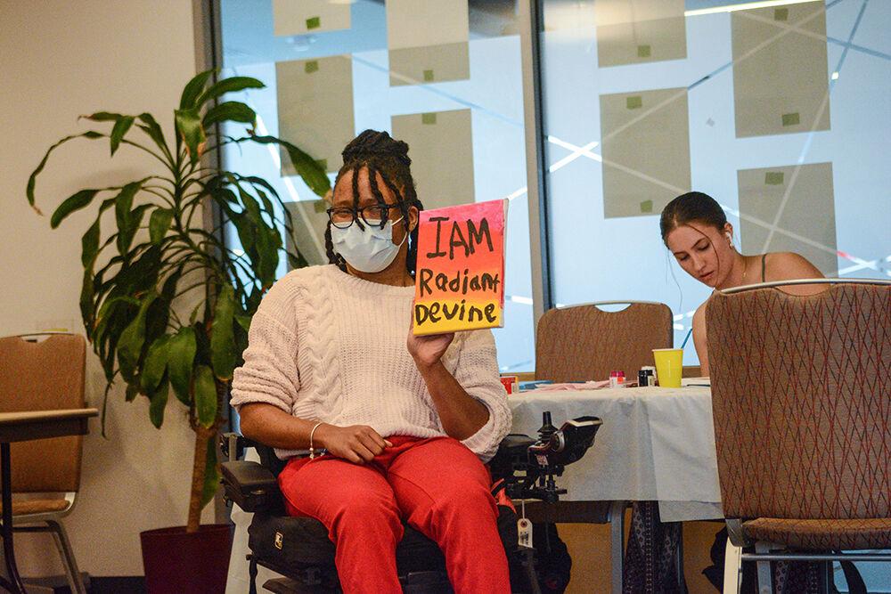 Alexus Smith, a graduate in English, shows her painting during the Women's Center event called "I'm Every Woman Interactive Storyteling Workshop" on Friday, March 25, 2022.&#160;