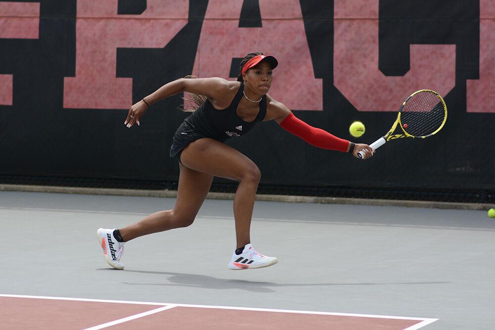 Graduate student Jaeda Daniel reaches for the ball during the match against Notre Dame on Saturday, April 16, 2022 at Dail Outdoor Tennis Stadium. The Wolfpack won 7-0.