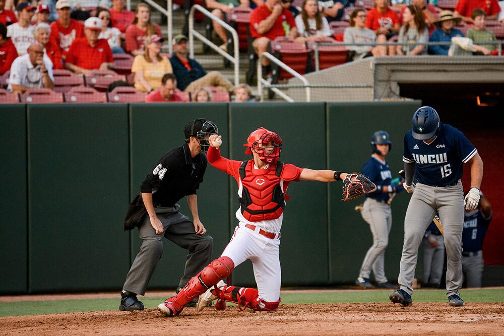 Freshman catcher Jacob Cozart returns the ball to the pitcher during the baseball game against UNC-Wilmington at Doak Field on Tuesday, April 12, 2022. The Wolfpack beat the Seahawks 7-6.
