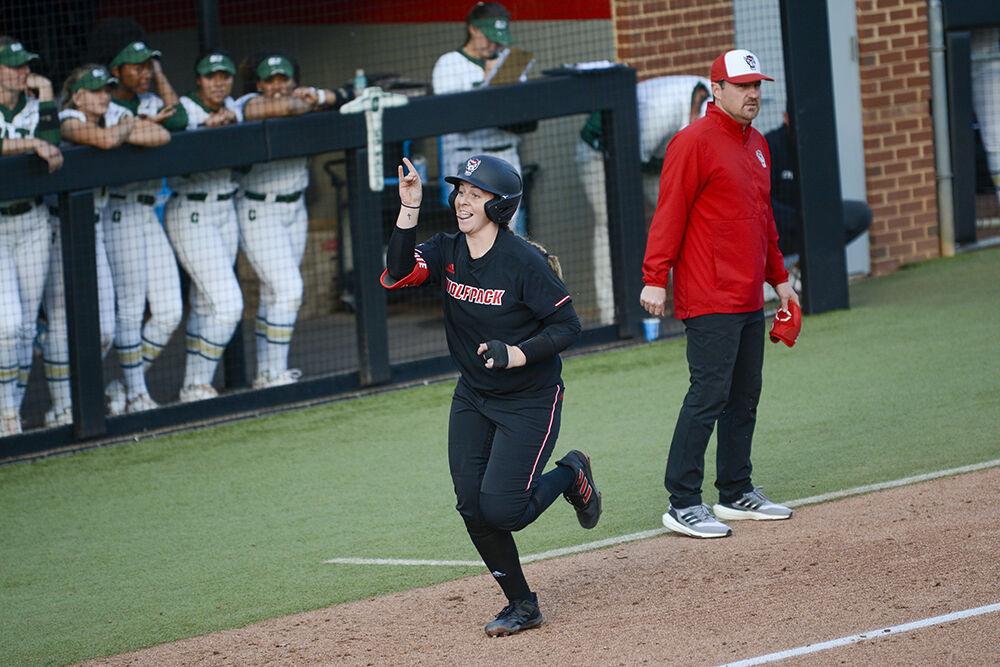 Graduate student Sam Sack throws up Wolfies during the game against UNC-Charlotte on Wednesday, March 30, 2022 at Dail Softball Stadium. Sack hit one homerun during the Wolfpack's 9-4 win over the 49ers.