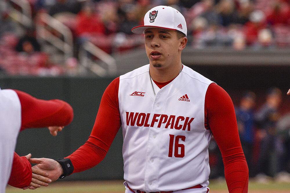 Sophomore pitcher Chris Villaman celebrates a 1-2-3 inning with the team during the Wolfpack's home baseball game against the Quinnipiac Bobcats at Doak Field on Feb. 26, 2022.&#160;The Wolfpack beat the Bobcats 12-10 to win the series.
