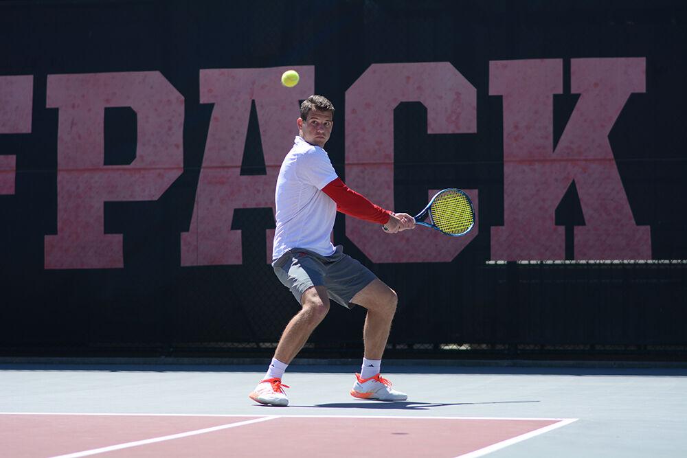 Junior Martins Rocens prepares to backhand the ball during the match against Clemson on Sunday, April 10, 2022 at Dail Outdoor Tennis Stadium. Rocens won his singles match 2-0 and the Wolfpack beat the Tigers 5-2.