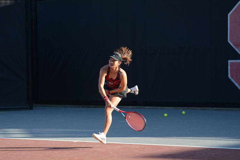 Freshman Priskya Nugroho follows through after a serve during the match against Duke at Dail Outdoor Tennis Stadium on Friday, April 1, 2022. The Wolfpack lost to the Blue Devils&#160;4-3.