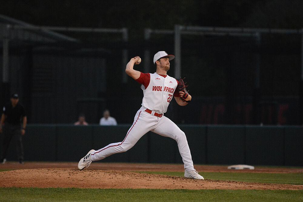 Junior pitcher Baker Nelson pitches the ball during the baseball game against UNC-Wilmington at Doak Field on Tuesday, April 12, 2022. The Wolfpack beat the Seahawks 7-6.
