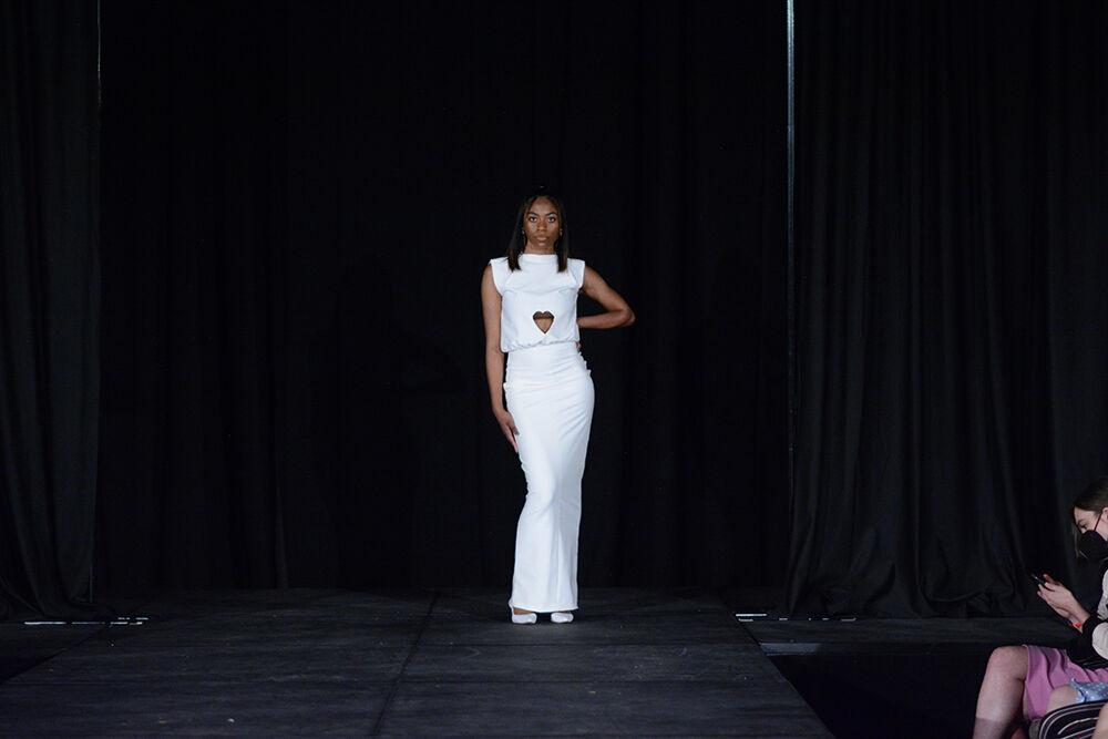 Designer and model Jada Williams shows off her own collection and poses on the runway on Thursday, April 7, 2022 at the African American Textile Society's 24th Annual Fashion Expos&#233; in Talley State Ballroom. Williams' collection was called "Purity" and its central theme was what it means to be black.