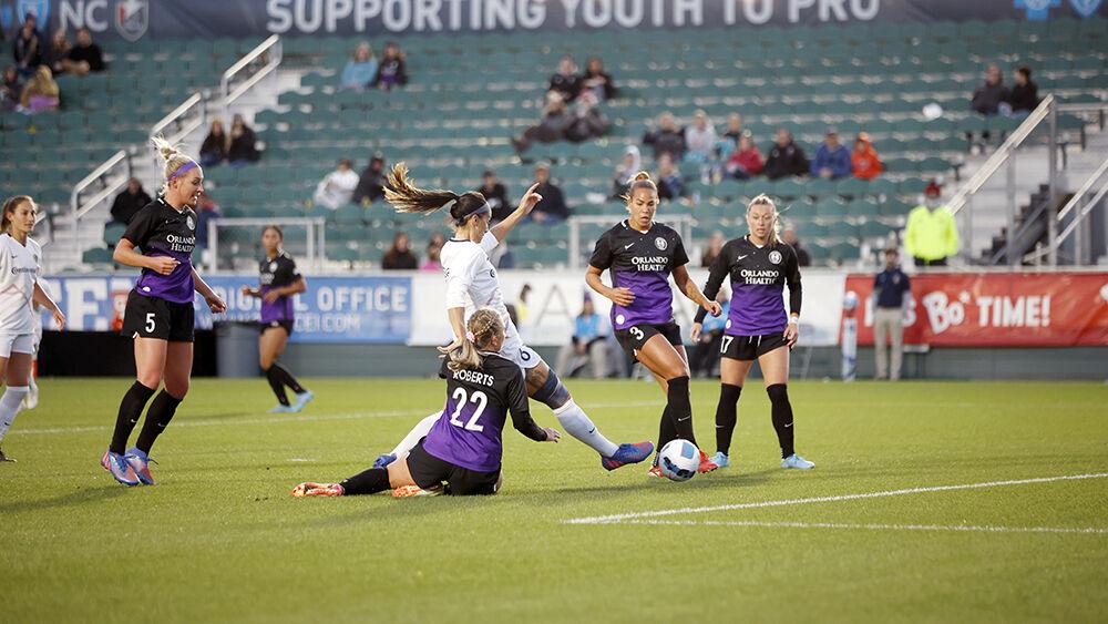 NC Courage defender Abby Erceg kicks the ball past an Orlando Pride defender on Saturday, March 26, 2022 in Sahlen&#8217;s Stadium at WakeMed Soccer Park. NC Courage beat Orlando Pride in the preseason match 1-0.