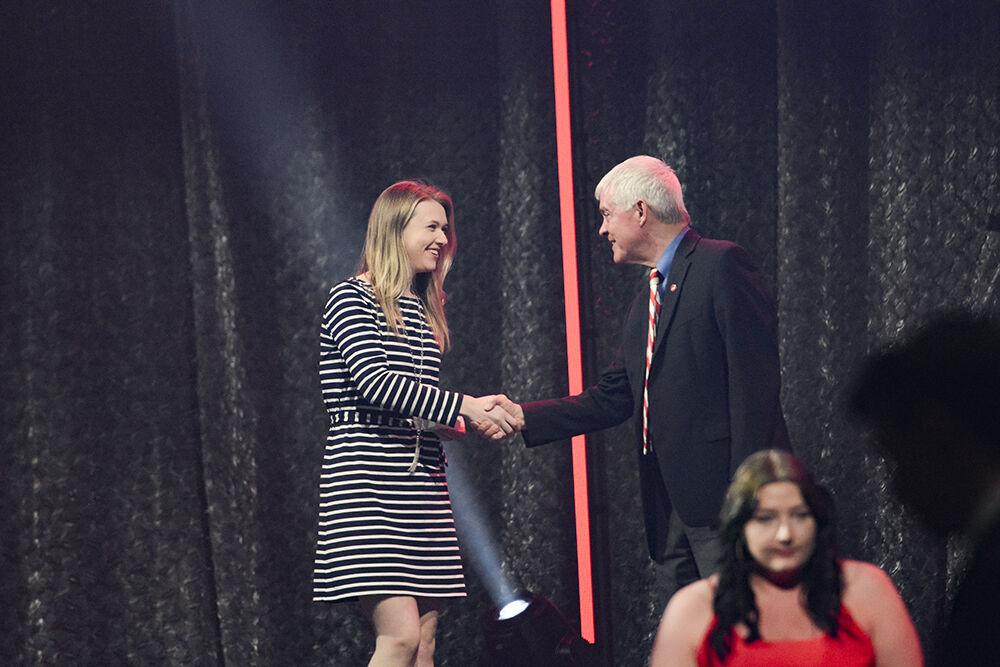 Callie Lewis, a fourth-year in poultry science and agricultural business management, shakes Dr. Tom Stafford's hand during the Ring Ceremony in Reynolds Coliseum on Wednesday, April 27, 2022. The Alumni Association held the ceremony for all the students and alumni who have completed 60 or more undergraduate credits or studied in a master's or doctoral program.
