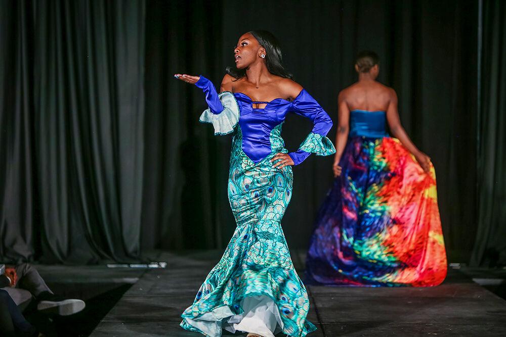 A model blows a kiss to the crowd as she shows off the collection of designers Destiny Hill and Sydni Mottley during the 24th Annual Fashion Expos&#381;, hosted by the African American Textile Society as part of Pan-Afrikan Week, in Talley Student Union on Thursday, April 7, 2022. Hill and Mottley won the Intermediate category with a collection that featured draped fabrics and bright colors.