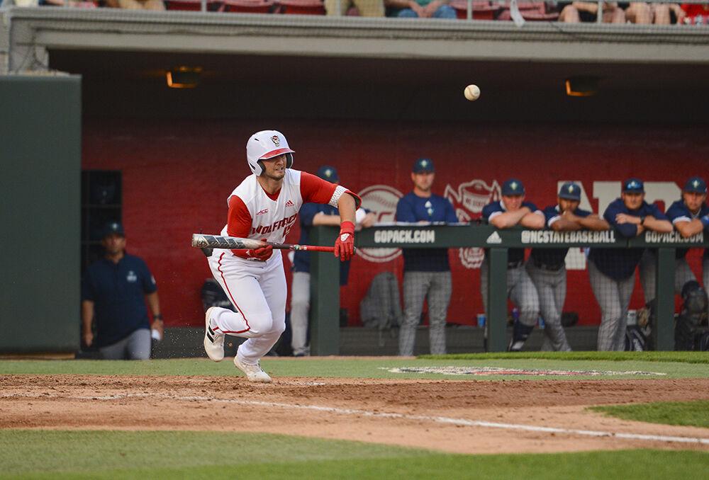 Senior infielder J.T. Jarrett bunts the ball during the baseball game against UNC-Wilmington at Doak Field on Tuesday, April 12, 2022. The Wolfpack beat the Seahawks 7-6.