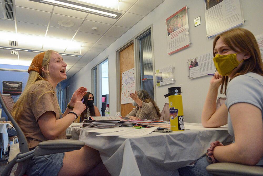 Maddie Lowry, a first-year in social work, and Martha Davies-Cutting, a first-year in psychology, laugh during the Women's Center event called "I'm Every Woman Interactive Storyteling Workshop" on Friday, March 25, 2022.&#160;