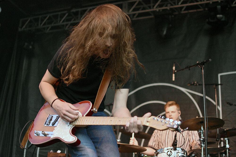 Josh Harmon, vocalist and guitarist for The Backseat Lovers, leans in to guitar while playing a song during Wolfstock at Stafford Commons on Monday, April 25, 2022. The Backseat Lovers were the second in the lineup for the Wolfstock concert.