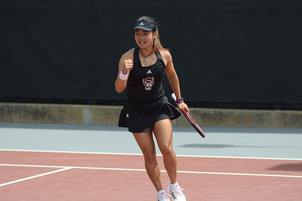 Freshman Priska Nugroho smiles as she celebrates a point during the match against Notre Dame on Saturday, April 16, 2022 at Dail Outdoor Tennis Stadium. Nugroho won her singles match 2-0. The Wolfpack won 7-0.