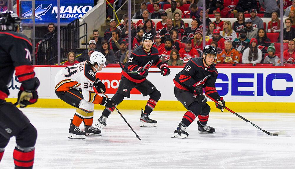 Carolina Hurricanes center Max Domi evades a pursuing defender during the game against the Anaheim Ducks on Sunday, April 10, 2022 in PNC Arena. The Hurricanes beat the Ducks 5-2.