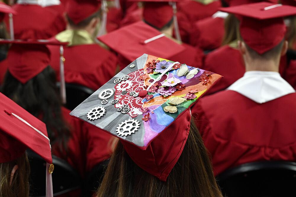 A decorated graduation cap sits on a graduate's head during the NC State Commencement in PNC Arena on Saturday, March 7, 2022.