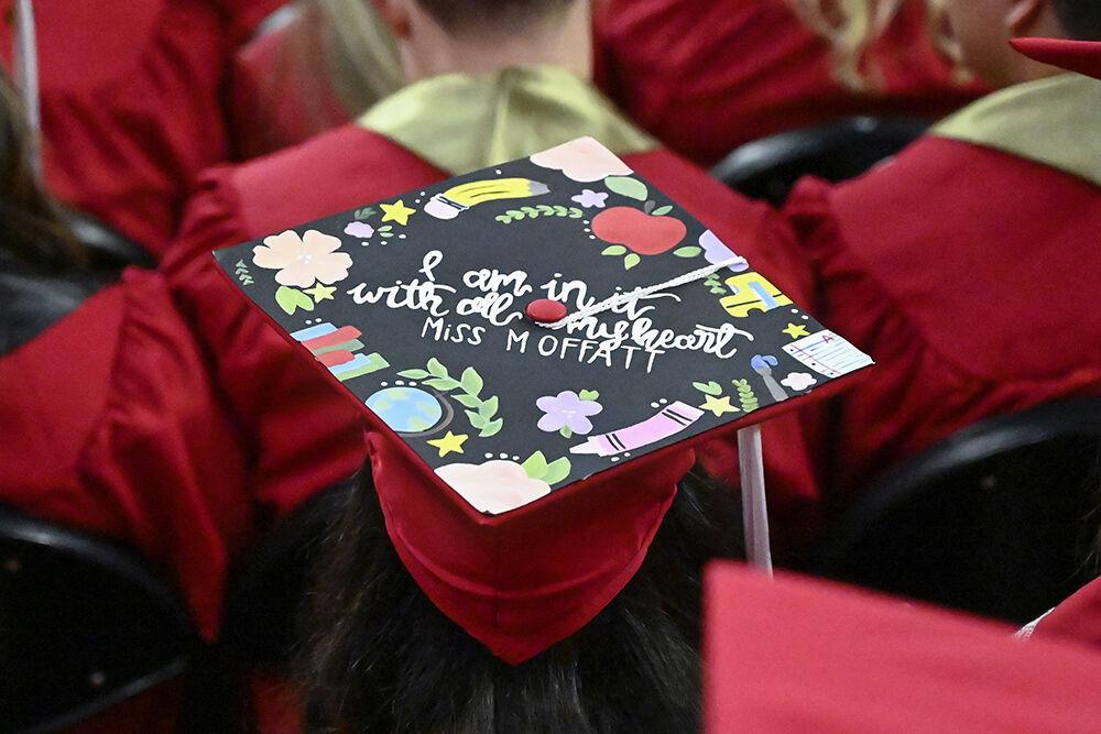 A student graduating in education wears a decorated cap during the NC State Commencement ceremony in PNC Arena on Saturday, May 7, 2022.