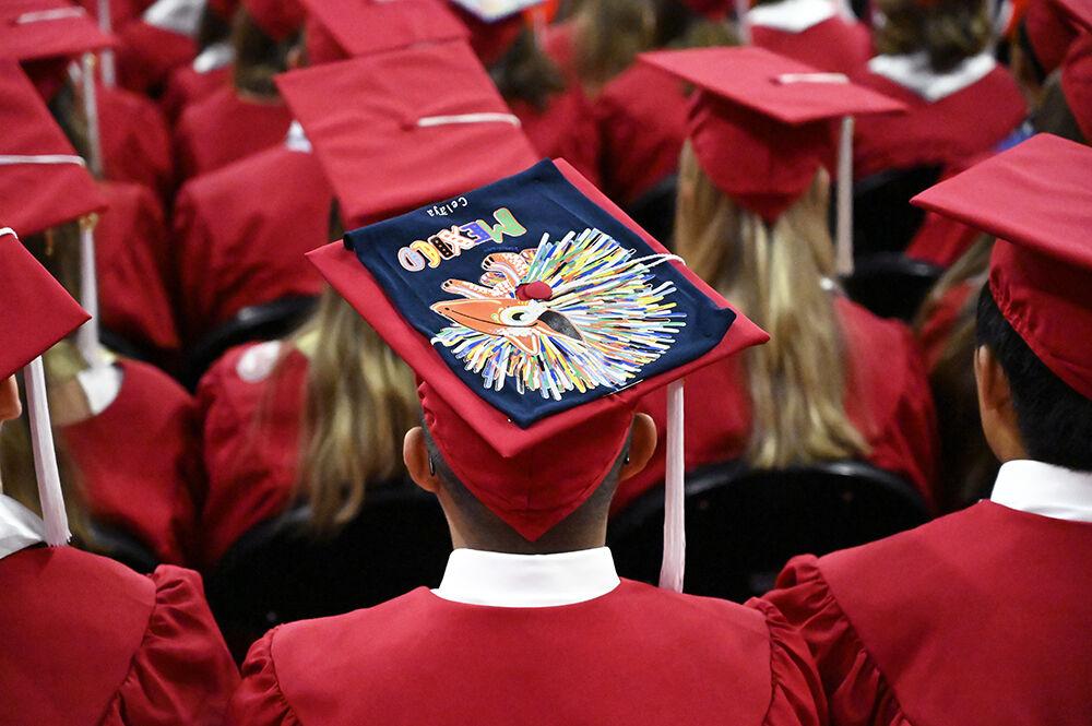 A decorated graduation cap sits on a graduate's head during the NC State Commencement in PNC Arena on Saturday, March 7, 2022.