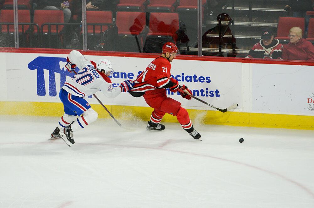 Carolina Hurricanes right wing Nino Niederreiter chases a puck as his jersey is grabbed by a defender during the game against Montreal on Thursday, March 31, 2022 in PNC Arena. The Hurricanes shutout the Canadiens 4-0.
