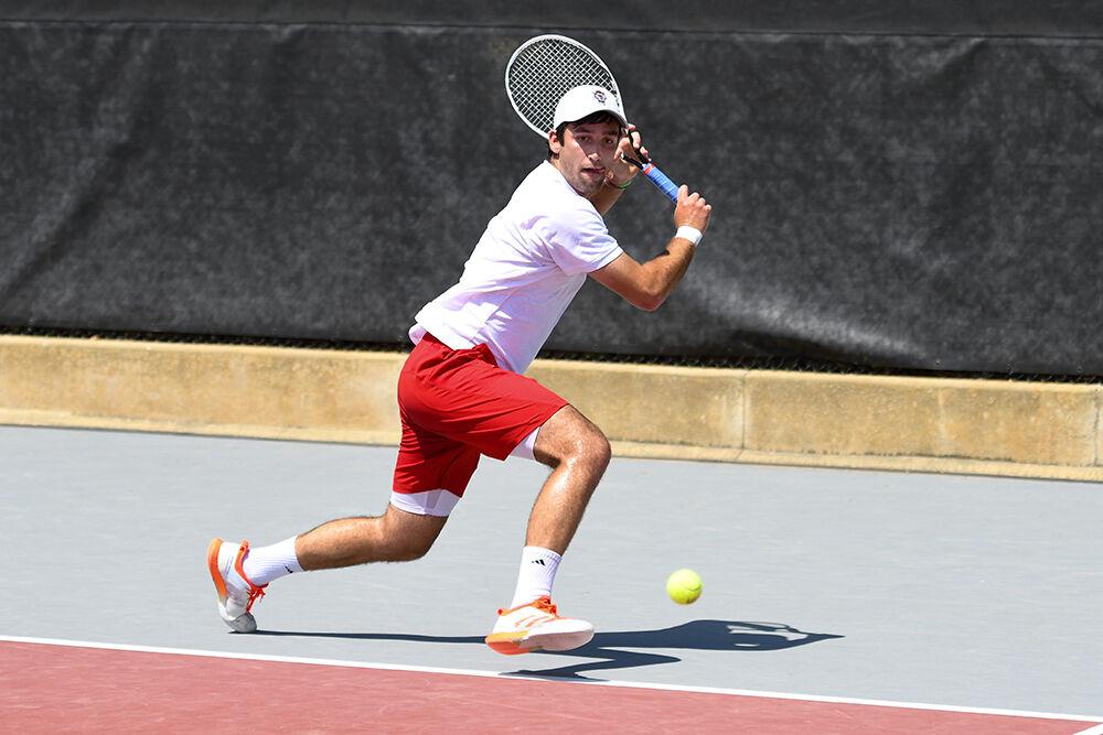 Senior Rafa Izquierdo Luque begins to make a backhand swing in his singles match against UNC-Chapel Hill player Brian Cernoch on Sunday, April 17, 2022 at the J.W. Isenhour Tennis Center. Izquierdo Luque lost his singles match with a score of 2-1. NC State lost to UNC-Chapel Hill 4-3.
