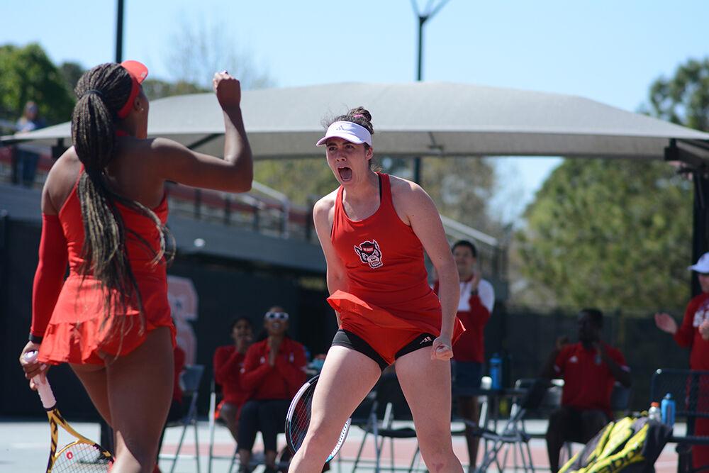 Senior Nell Miller celebrates winning a set with her doubles partner graduate student Jaeda Daniel during the match against UNC-Chapel Hill on Sunday, April 3, 2022 at Dail Outdoor Tennis Stadium. Miller and Daniel won their doubles match 6-3. The Wolfpack lost to the Tar Heels 4-3.