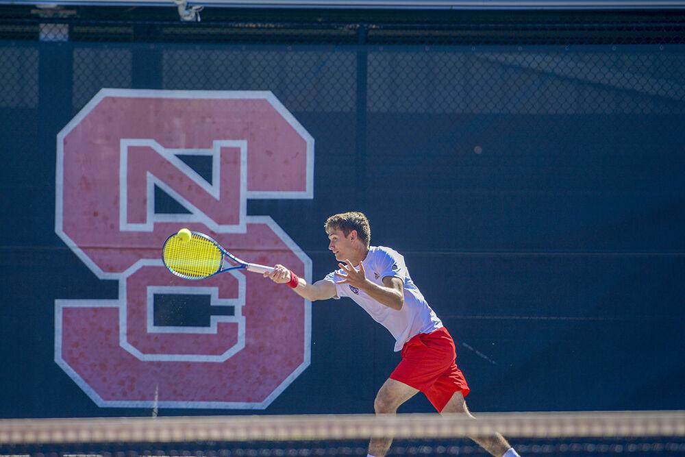 Graduate student Collin Shick knocks the ball back into the court during his doubles match against Northeastern on Monday, March 21, 2022 at the J.W. Isenhour Tennis Center. NC State beat Northwestern 4-2.