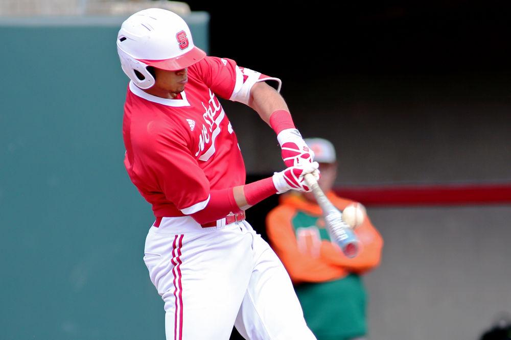 Junior infielder Joe Dunand connects with the ball on March 19, 2017 at Doak Field. The Wolfpack lost to Miami 7-5.