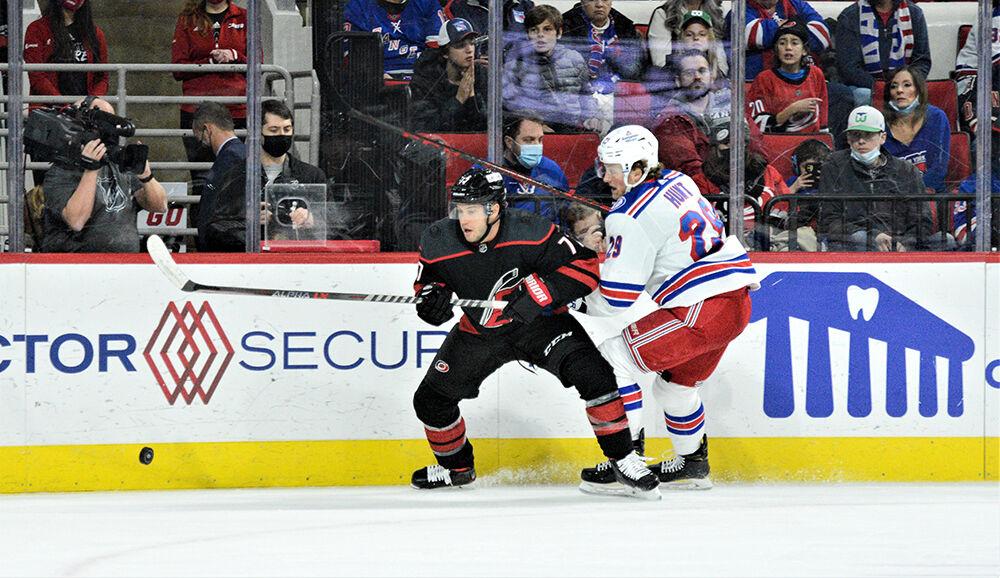 Right defensemen Tony DeAngelo eyes for the puck in PNC Arena on Friday, Jan. 21, 2022. The Hurricanes beat the New York Rangers 6-3.