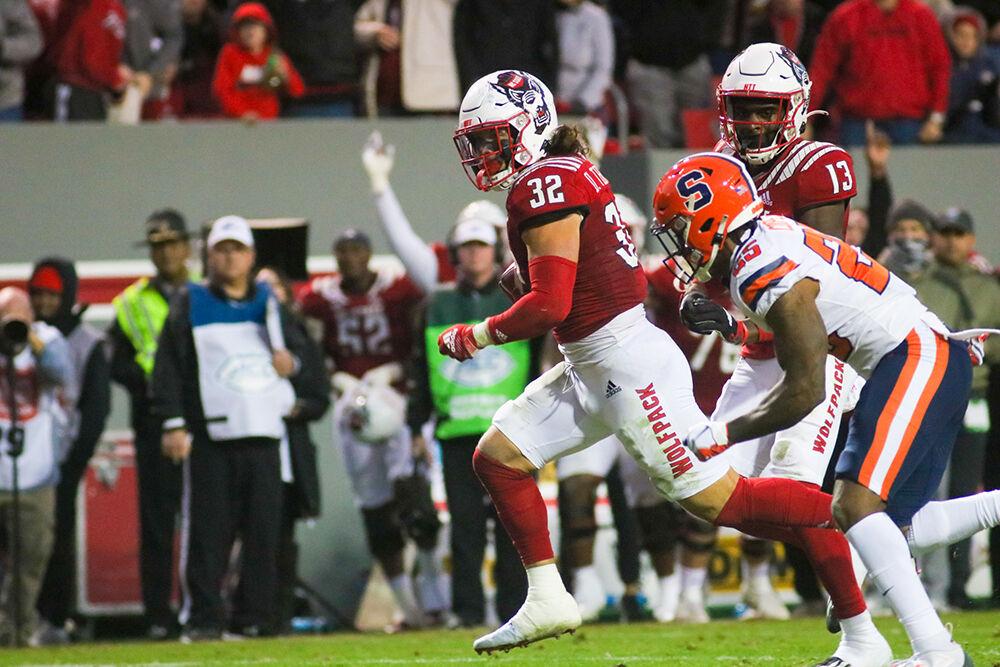 Sophomore linebacker Drake Thomas intercepts the ball and runs towards the end zone on Saturday, Nov. 20, 2021 at Carter-Finley Stadium. Thomas had four tackles and two sacks throughout the night. The Wolfpack won 41-17 against the Orange.