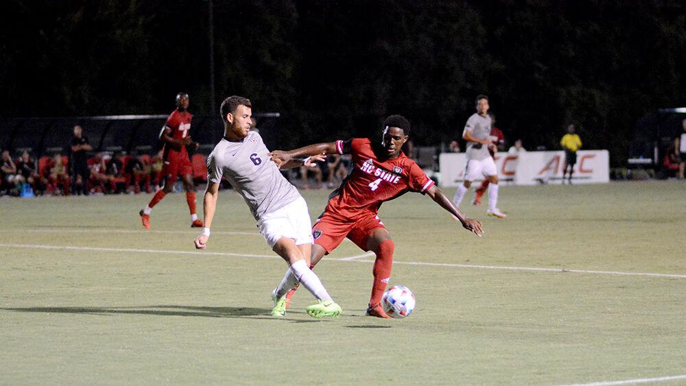 Freshman midfielder Vusumzi Plamana fights for the ball against a UCF player at Dail Soccer Stadium on Monday, Sep. 6, 2021. NC State beat UCF 2-1.