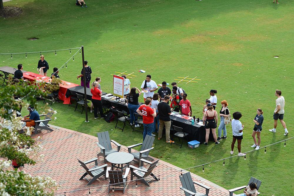 Students line up to sign the Student Media interest form during the Witherspoon Block Party at Harris Field on Monday, Aug. 22, 2022. Witherspoon's Block Party was an event during Wolfpack Welcome Week that was to help students get involved with the organizations that are in Witherspoon Student Center.