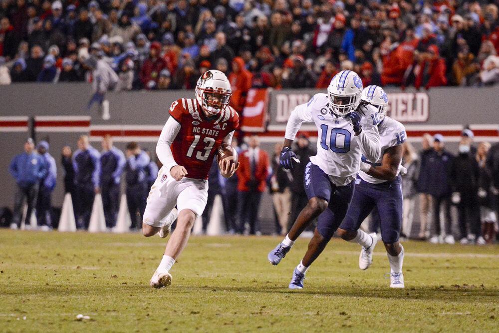 Redshirt sophomore quarterback Devin Leary runs with the ball in the game versus UNC-Chapel Hill on Friday, Nov. 26, 2021 at Carter-Finley Stadium. Leary had 247 passing yards during the game. The Wolfpack beat the Tar Heels 34-30.