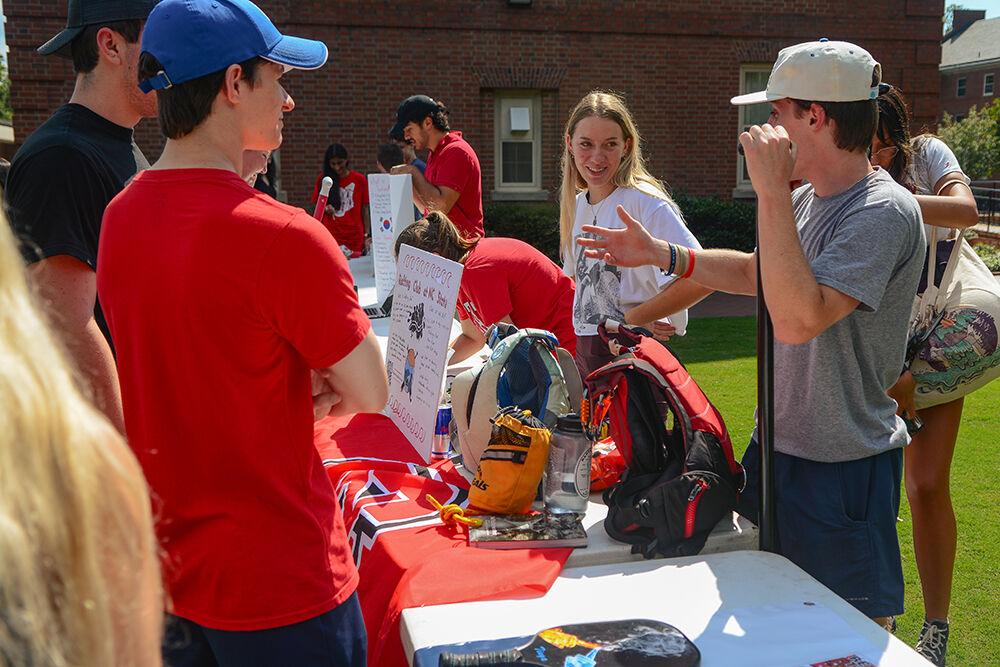 (On left) Ben Stevens, a second-year studying business administration listens to Andrew Beckert, a third-year studying finance, explain the Rafting Club at the Student Involvement Fair at Stafford Commons on Friday, Aug. 26, 2022. The Student Involvement Fair gave clubs at NC State the opportunity to put their groups on display for other students at NC State.