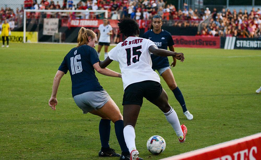 Senior forward Jameese Joseph steals the ball from a Georgetown player during the match against the Hoyas on Sunday, Aug. 28, 2022 at Dail Soccer Field. Jospeh had one goal during the match. The Wolfpack tied the match 2-2.