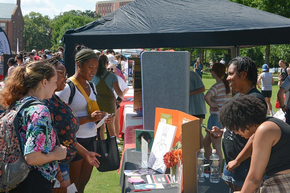 Members of the Black Artist Coalition give information about their club to NC State students at the Student Involvement Fair at Stafford Commons on Friday, Aug. 26, 2022. The Black Artist Coalition was a club dedicated to creating a space for black artists to express their talent and grow at NC State.
