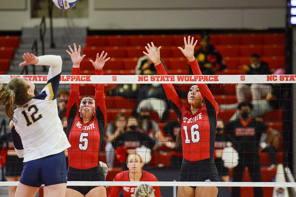 Junior setter Kristen McDaniel and freshman middle blocker Jada Allen attempt to block a spike during the game against Notre Dame on Sunday, Nov. 7, 2021 in Reynolds Coliseum. The Wolfpack beat the Fighting Irish 3-2.