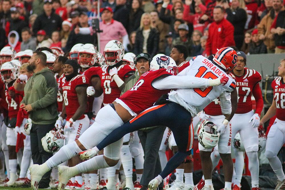 Graduate student defensive tackle Corey Durden tackles Syracuse quarterback Garrett Shrader on Saturday, Nov. 20, 2021 at Carter-Finley Stadium. Durden had four tackles throughout the night. The Wolfpack won 41-17 against the Orange.