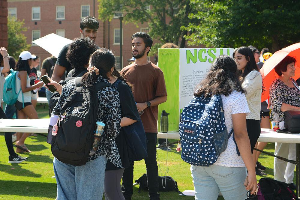 Members from the Pakistani Student Association at NC State give information about their club to a group of students at the Student Involvement Fair at Stafford Commons on Friday, Aug 26, 2022. The Student Involvement Fair was an event that allowed students to interact with a wide variety of clubs and organizations to see which ones they would be interested in.
