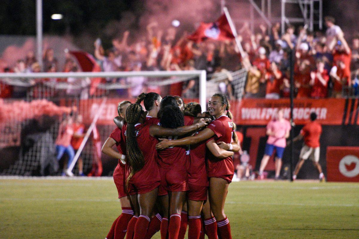 The NC State Women's team embrace each other after their only goal at the last minute of the match versus the Campbell Camels on Thursday, Aug. 25, 2022 in Dail Soccer Field. The Wolfpack beat the Camels 1-0.